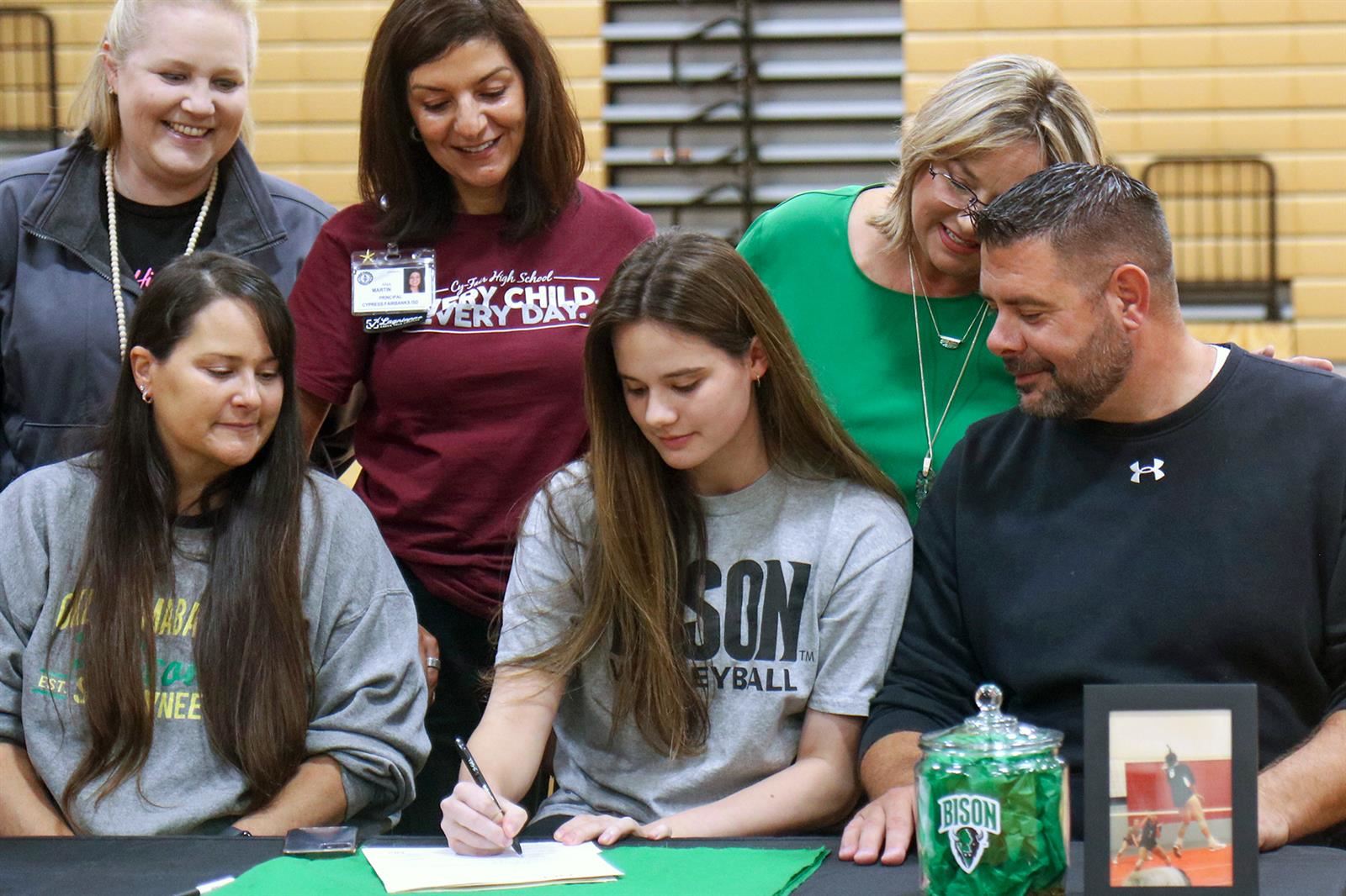 Cy-Fair High School senior Payton Rink, seated center, signs her letter of intent to play volleyball.